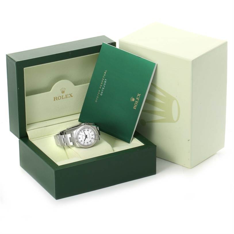 The image shows a Mid-Size Rolex watch in an open box with a green booklet, viewed from a front angle.