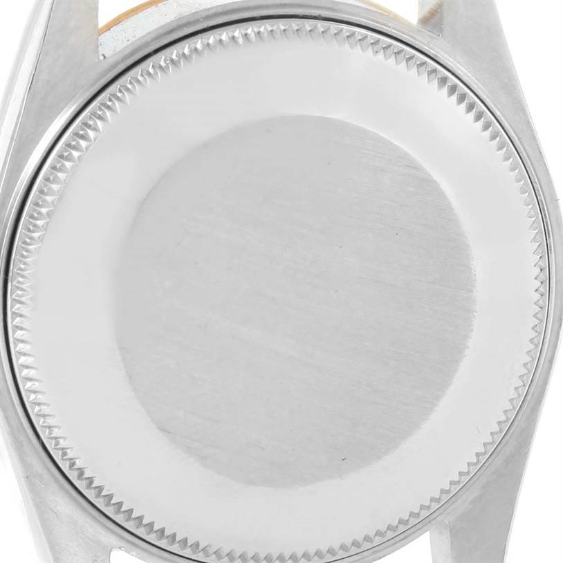 This image shows the case back of a Rolex Mid-Size 68273 Women's Steel and Gold (two tone) Champagne Dial 68273 Women's Steel and Gold (two tone) Champagne Dial watch from a top-down angle.