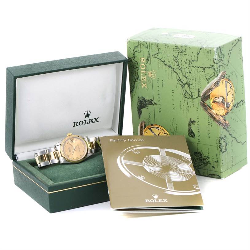 The image shows a Mid-Size Rolex watch in an open display box, alongside factory service booklets and packaging.