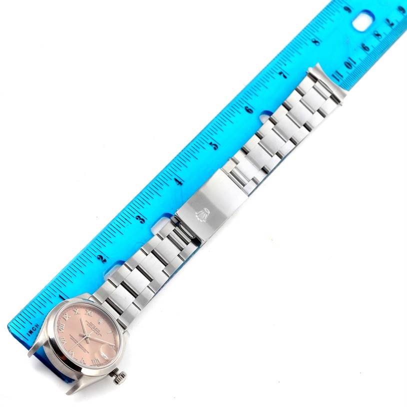 The image shows a Rolex Mid-Size 68240 Women's Stainless Steel Blue Dial 68240 Women's Stainless Steel Blue Dial watch laid flat next to a blue ruler, displaying the dial, bracelet, and clasp.