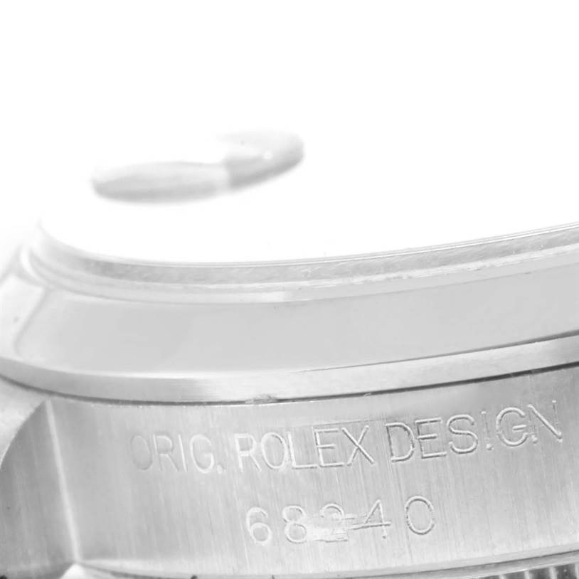 The image shows a close-up of the side of a Rolex Mid-Size 68240 Women's Stainless Steel Blue Dial 68240 Women's Stainless Steel Blue Dial watch case with the engraving "ORIG. ROLEX DESIGN 68240."