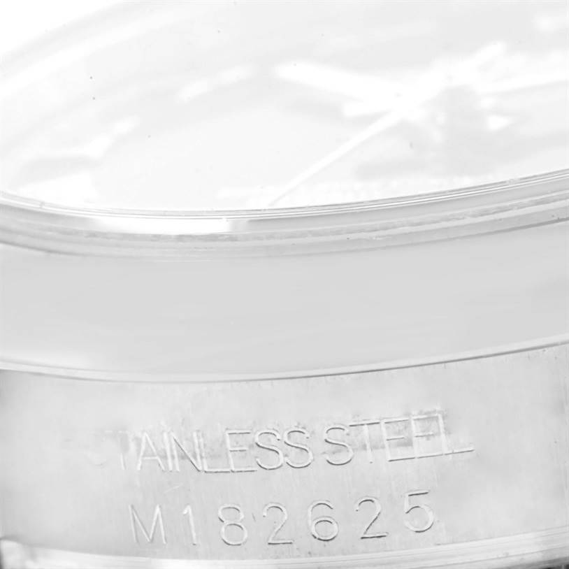 The image shows the side and part of the stainless steel bezel of a Rolex Mid-Size 178240 Women's Stainless Steel Blue Dial 178240 Women's Stainless Steel Blue Dial model, with the model number M182625 engraved.