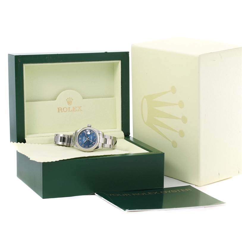 The Rolex Mid-Size 178240 Women's Stainless Steel Blue Dial 178240 Women's Stainless Steel Blue Dial model watch is displayed inside its green and cream box, with an additional booklet next to it.