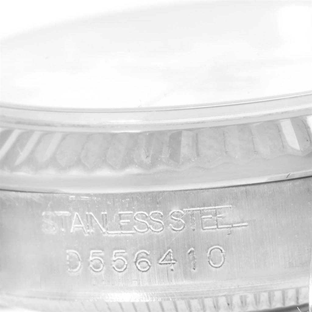 This image shows a close-up of the serial number and "STAINLESS STEEL" engraving on the side of a Rolex Mid-Size 178274 Women's Stainless Steel White Dial 178274 Women's Stainless Steel White Dial watch.