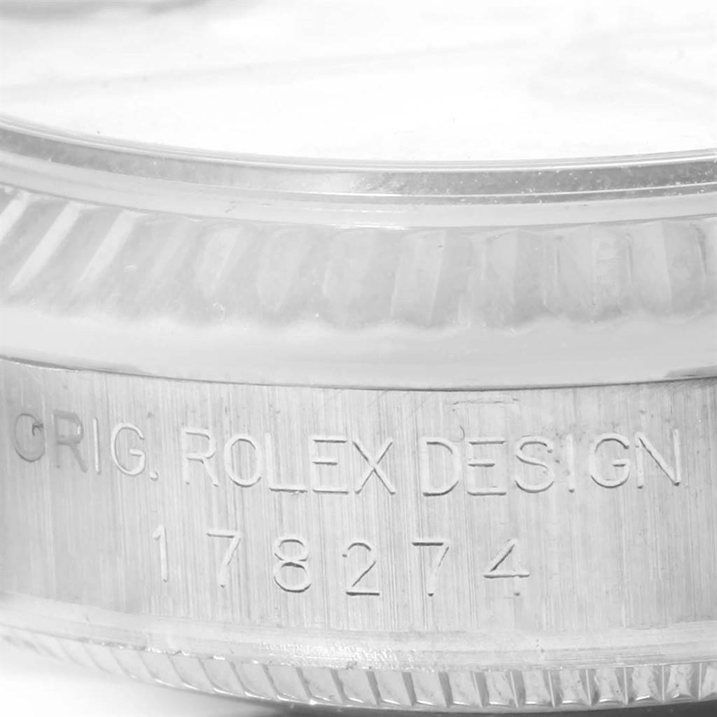 The image shows a close-up of the side of the case, bezel, and part of the crystal of a mid-size Rolex model 178274.