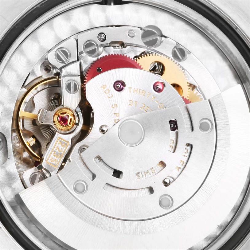 This image shows the intricate internal mechanism of a mid-size Rolex watch, photographed from the back.