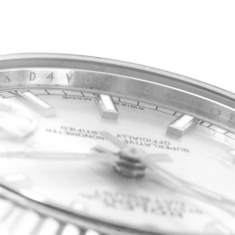 The image shows a close-up angle of the dial and inner bezel of a Mid-Size Rolex watch, highlighting the markings and indices.
