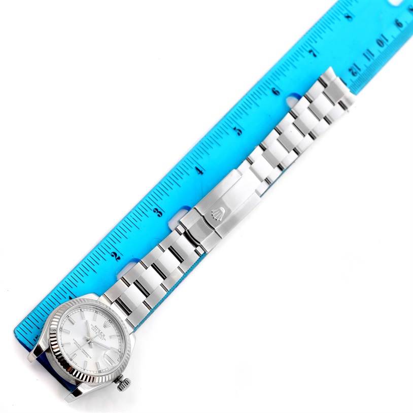 The image shows a Rolex Mid-Size 178274 Women's Stainless Steel Silver Dial 178274 Women's Stainless Steel Silver Dial model watch placed alongside a blue ruler, displaying the watch face and metal bracelet fully extended.