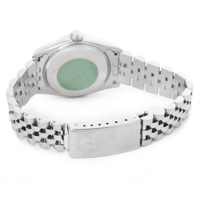 The image shows the back case and clasp of a Rolex Mid-Size 68240 Women's Stainless Steel Silver Dial 68240 Women's Stainless Steel Silver Dial model watch, displaying partial bracelet links and the green sticker.
