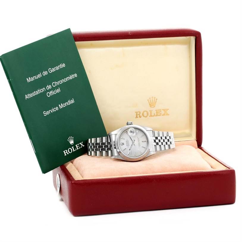 The Mid-Size Rolex watch is showcased in its box with warranty papers visible on the left.