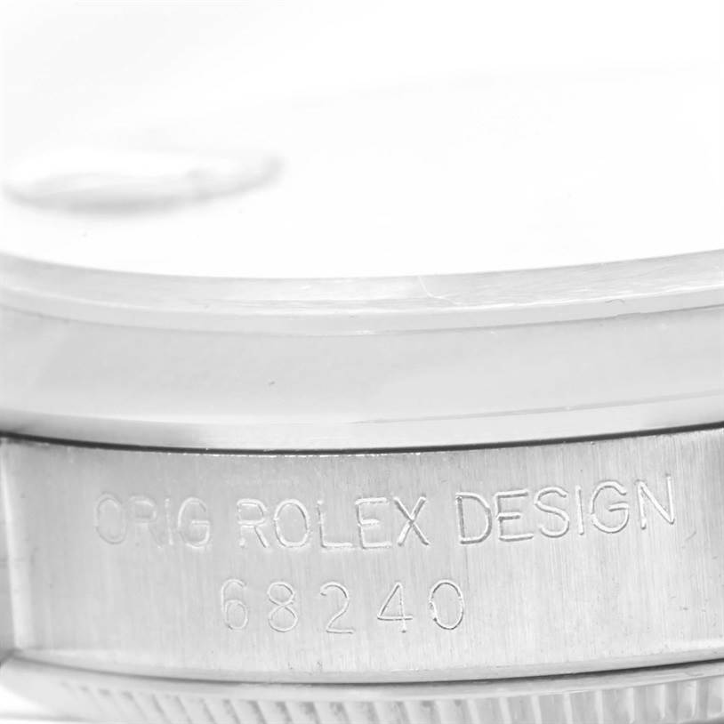 This image shows a close-up side view of the case of a Rolex Mid-Size 68240 Women's Stainless Steel Silver Dial 68240 Women's Stainless Steel Silver Dial model, displaying the "ORIG ROLEX DESIGN 68240" engraving.