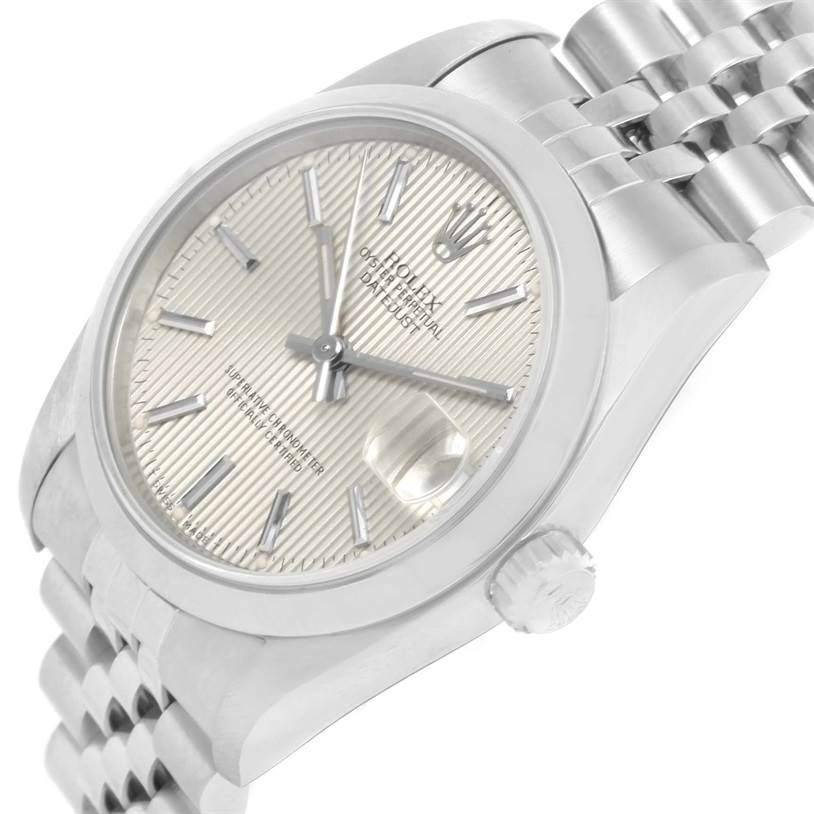 The image shows a close-up, angled view of the face and part of the band of a mid-size Rolex Datejust watch.