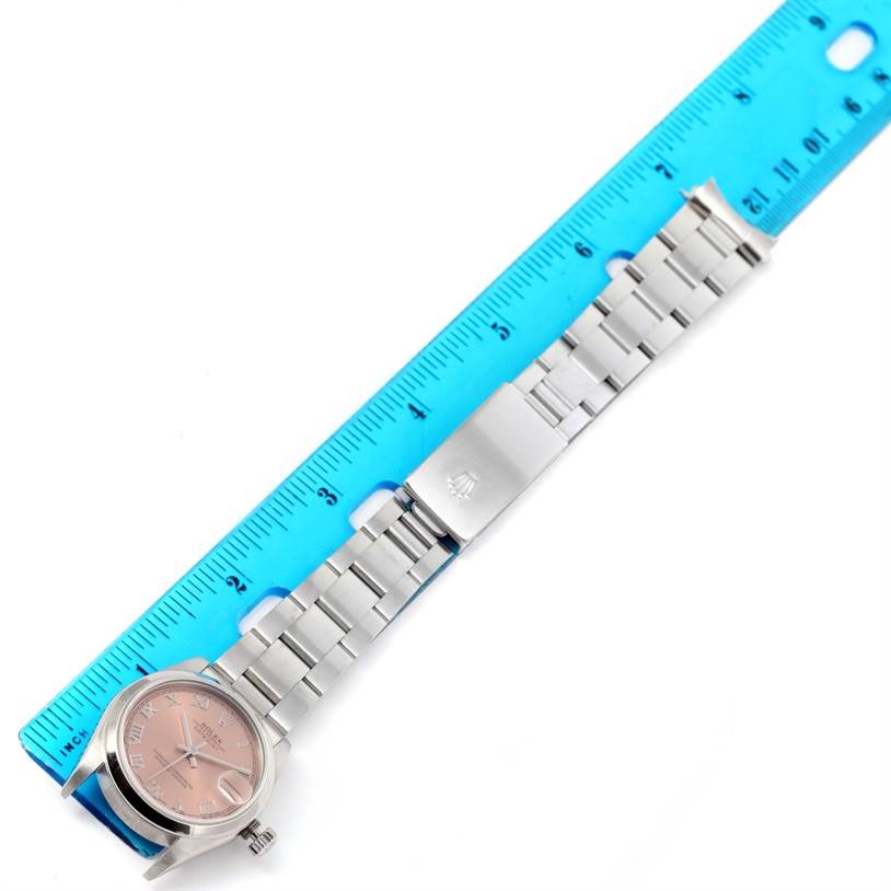 The image shows a Rolex Mid-Size 78240 Women's Stainless Steel Pink Dial 78240 Women's Stainless Steel Pink Dial watch laid flat next to a ruler, displaying the watch face, bracelet, and clasp.