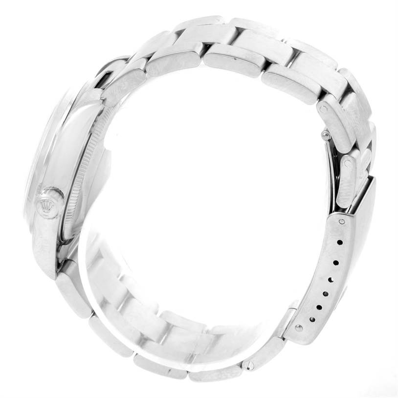 The image shows the side profile and strap of a Mid-Size Rolex watch, highlighting the bracelet and clasp.