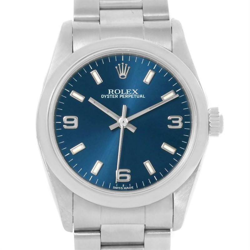 The image shows a Rolex Oyster Perpetual Mid-Size watch from the front, displaying its blue dial, silver markers, hands, and bracelet.