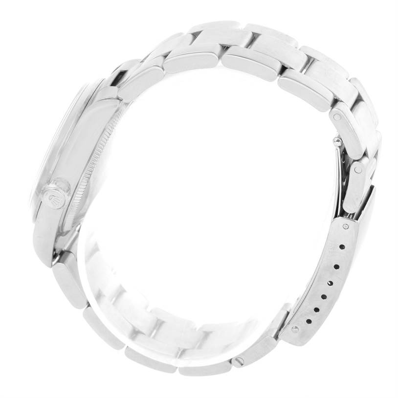 The image shows the side view of a Rolex Mid-Size 77080 Women's Stainless Steel Blue Dial 77080 Women's Stainless Steel Blue Dial watch, highlighting its case and bracelet.