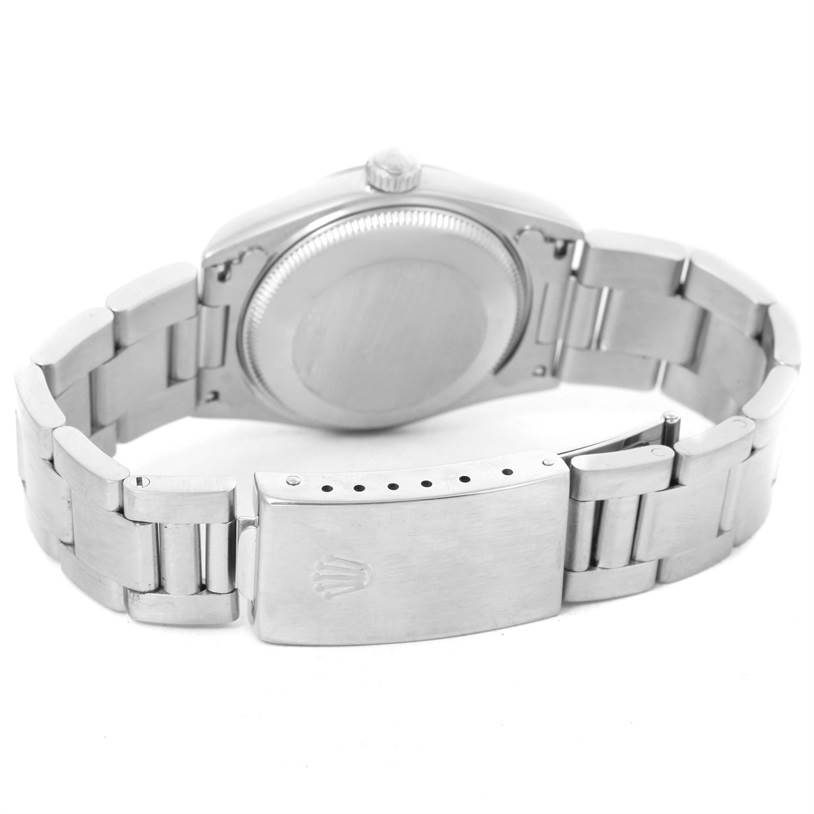 This image shows the back and clasp of a Mid-Size Rolex watch, capturing the bracelet and case back.