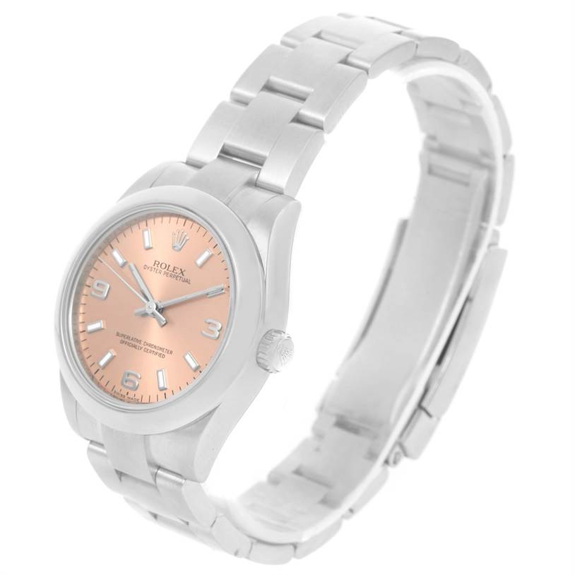 The image shows a side angle view of the Rolex Mid-Size 177200 Women's Stainless Steel Pink Dial 177200 Women's Stainless Steel Pink Dial watch, highlighting its bracelet, case, crown, and salmon-colored dial.