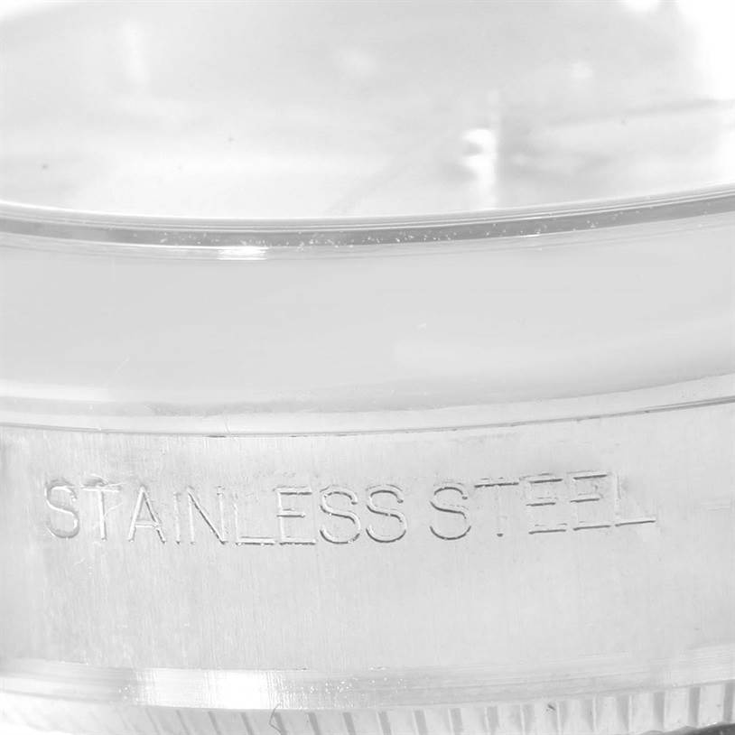This close-up image of a Rolex Mid-Size 177200 Women's Stainless Steel Silver Dial 177200 Women's Stainless Steel Silver Dial watch shows the case edge with "Stainless Steel" engraved.