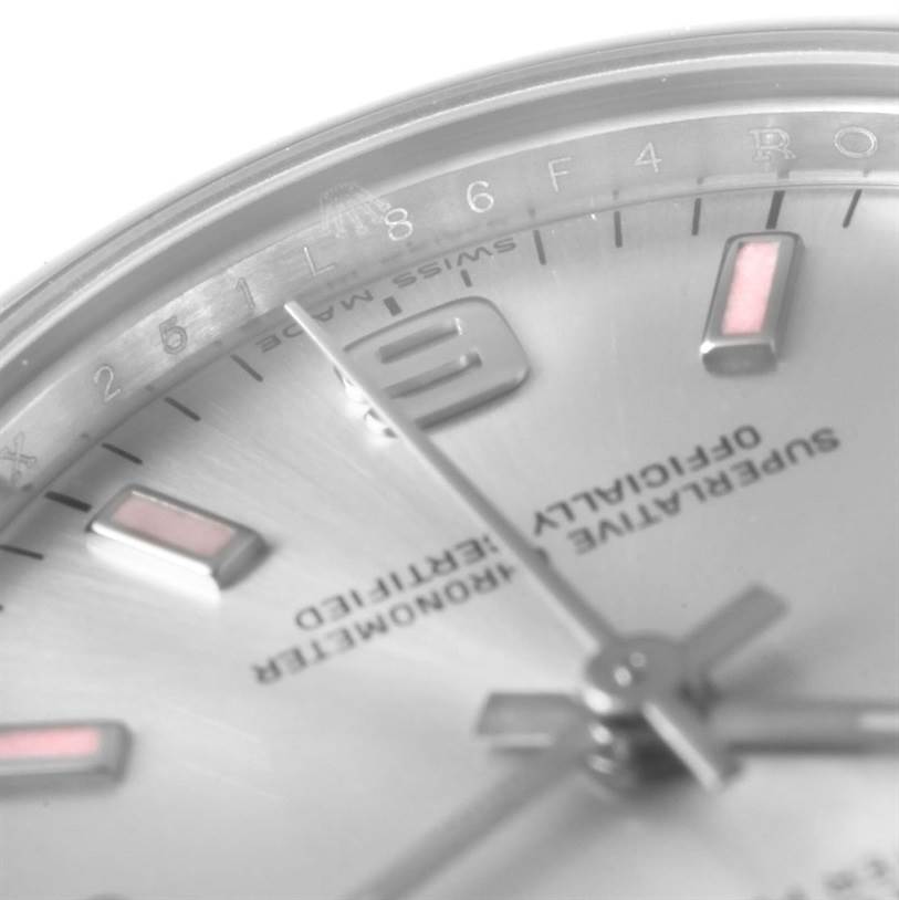 The image shows a close-up of the dial and hands of a Mid-Size Rolex watch from an angled top view.