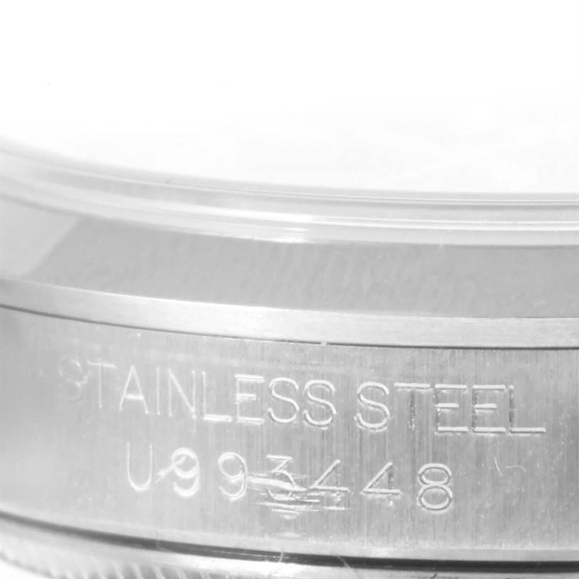 This close-up image shows the case side with stainless steel and the serial number engraving of a Mid-Size Rolex watch.