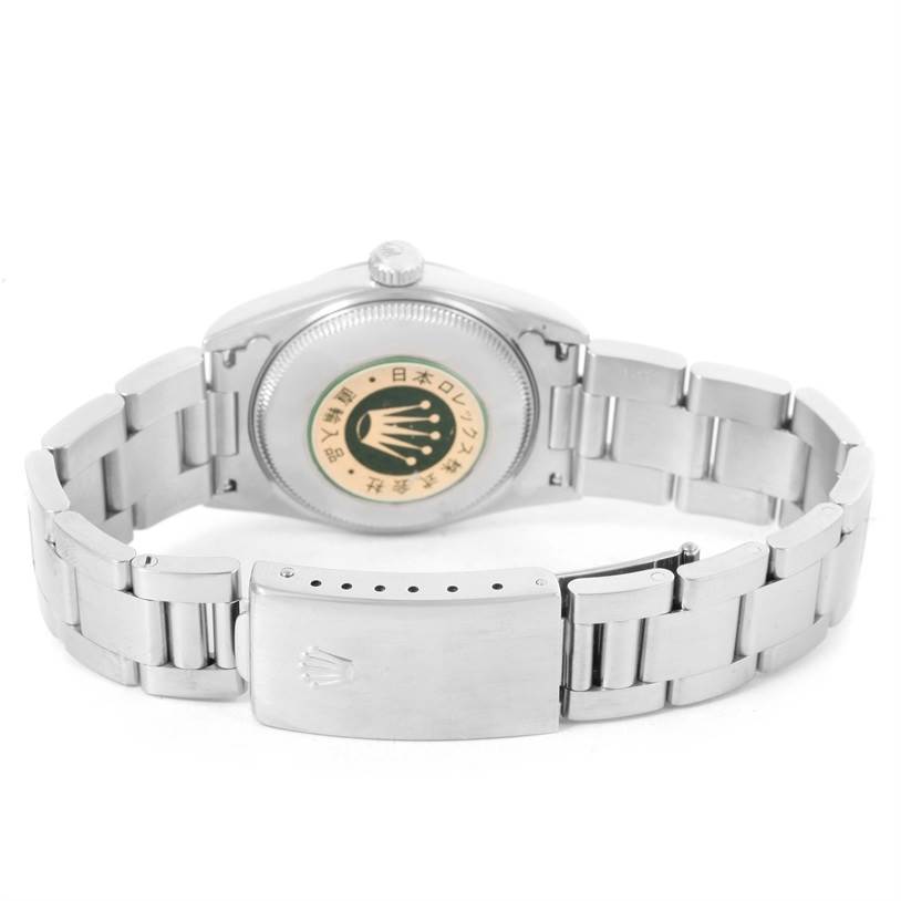 The image shows the back case and bracelet of a Mid-Size Rolex watch, viewed from a rear angle.