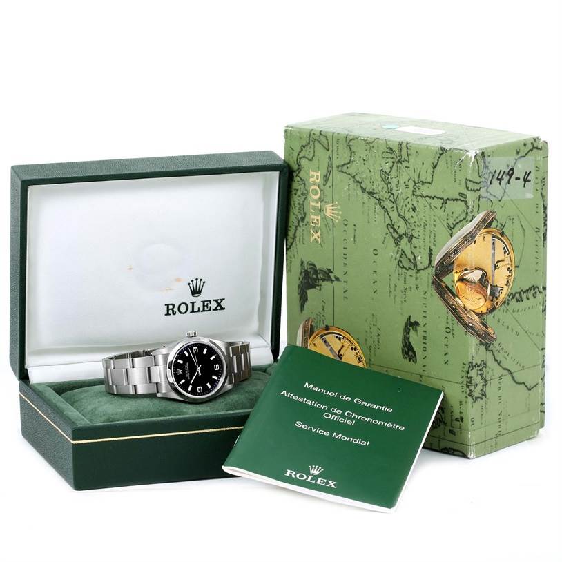 The image shows a Rolex Mid-Size 77080 Women's Stainless Steel Black Dial 77080 Women's Stainless Steel Black Dial watch inside its box, accompanied by the outer packaging and a warranty manual.