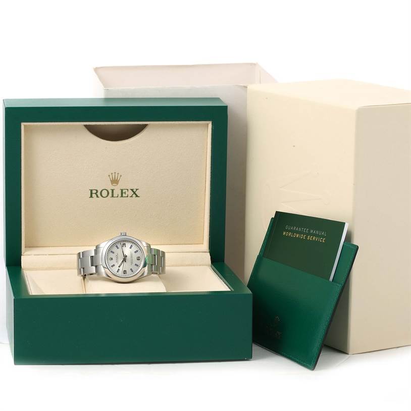 The Rolex Mid-Size 177200 Women's Stainless Steel Silver Dial 177200 Women's Stainless Steel Silver Dial watch is shown front-facing inside its box, accompanied by a guarantee manual and outer packaging.