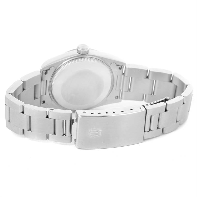 The image shows the back case and bracelet clasp of a Mid-Size Rolex watch from a rear angle.