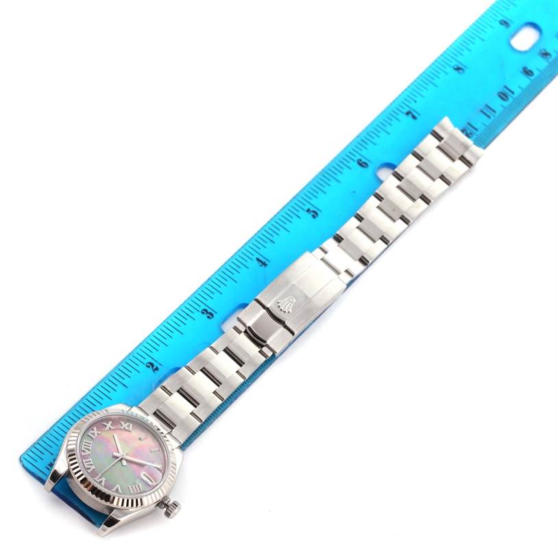 The image shows a Rolex Mid-Size 178274 Women's Stainless Steel Mother of Pearl Dial 178274 Women's Stainless Steel Mother of Pearl Dial model watch laid flat next to a ruler, displaying the watch face and the full bracelet with the clasp.