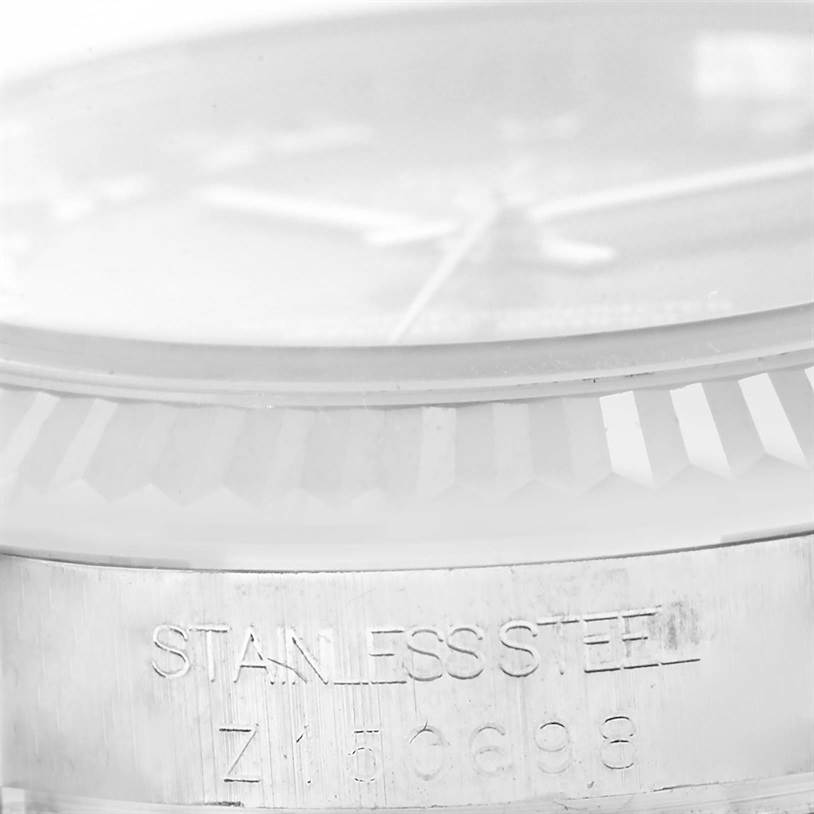 This close-up image shows the stainless steel bezel and part of the dial of a Rolex Mid-Size 178274 Women's Stainless Steel Mother of Pearl Dial 178274 Women's Stainless Steel Mother of Pearl Dial model watch.