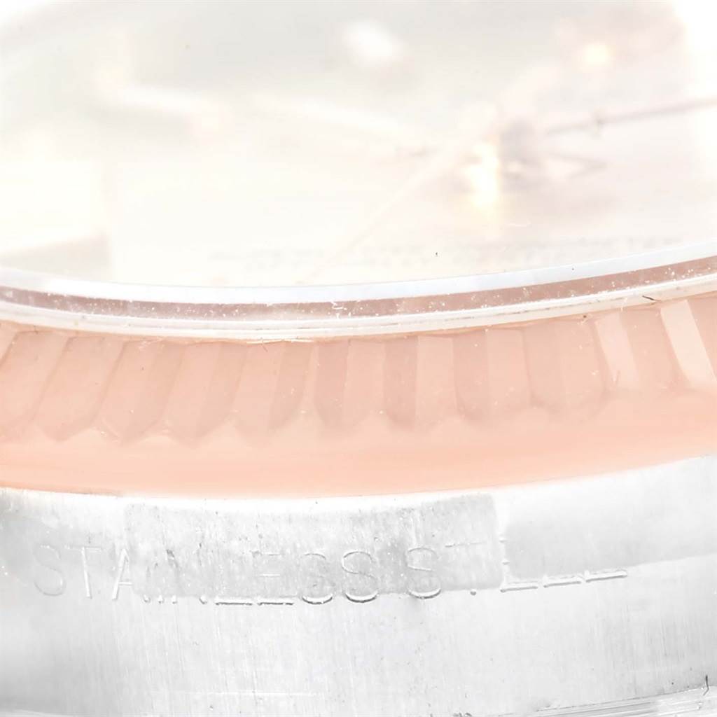 The image shows a close-up of the bezel and part of the dial of a Mid-Size Rolex watch.