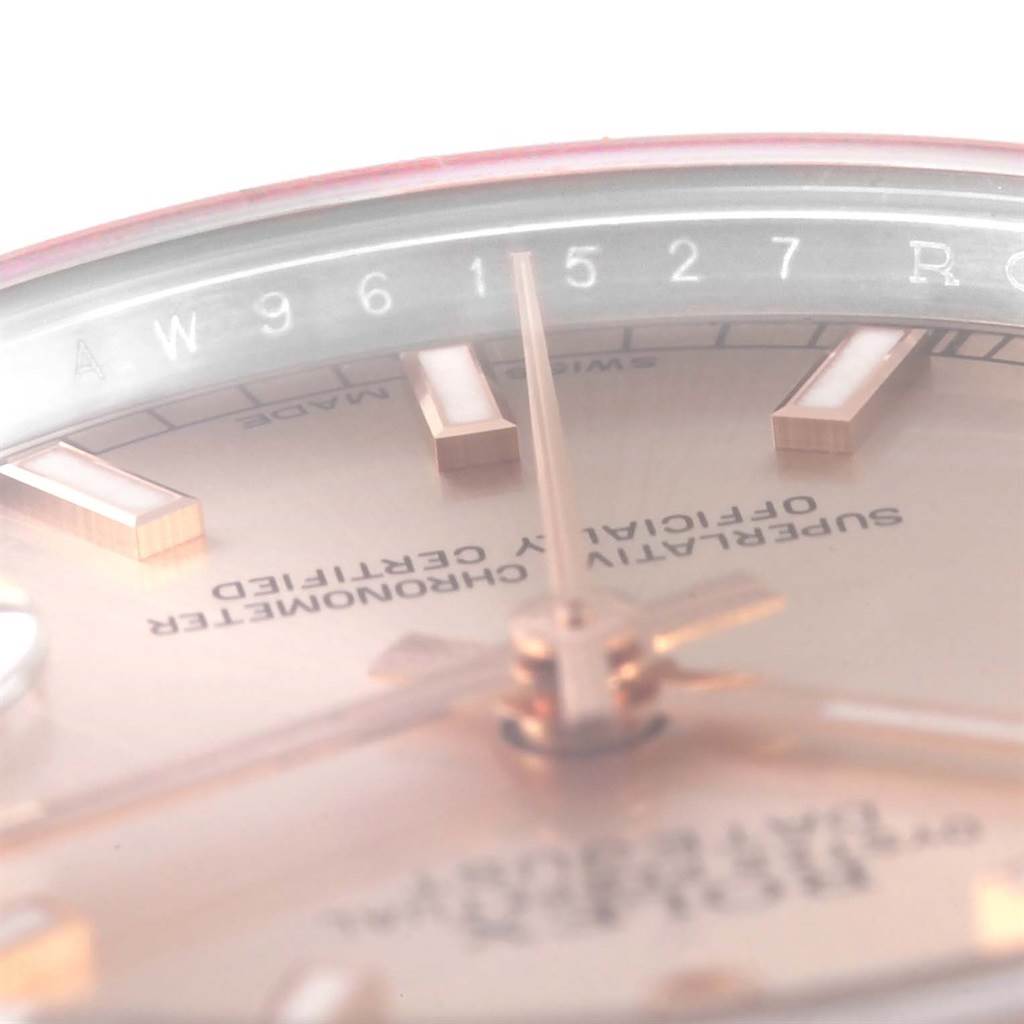 Close-up view of the dial, hands, and part of the rehaut of a Rolex Mid-Size 178271 Women's Steel and Gold (two tone) Pink Dial 178271 Women's Steel and Gold (two tone) Pink Dial model watch.