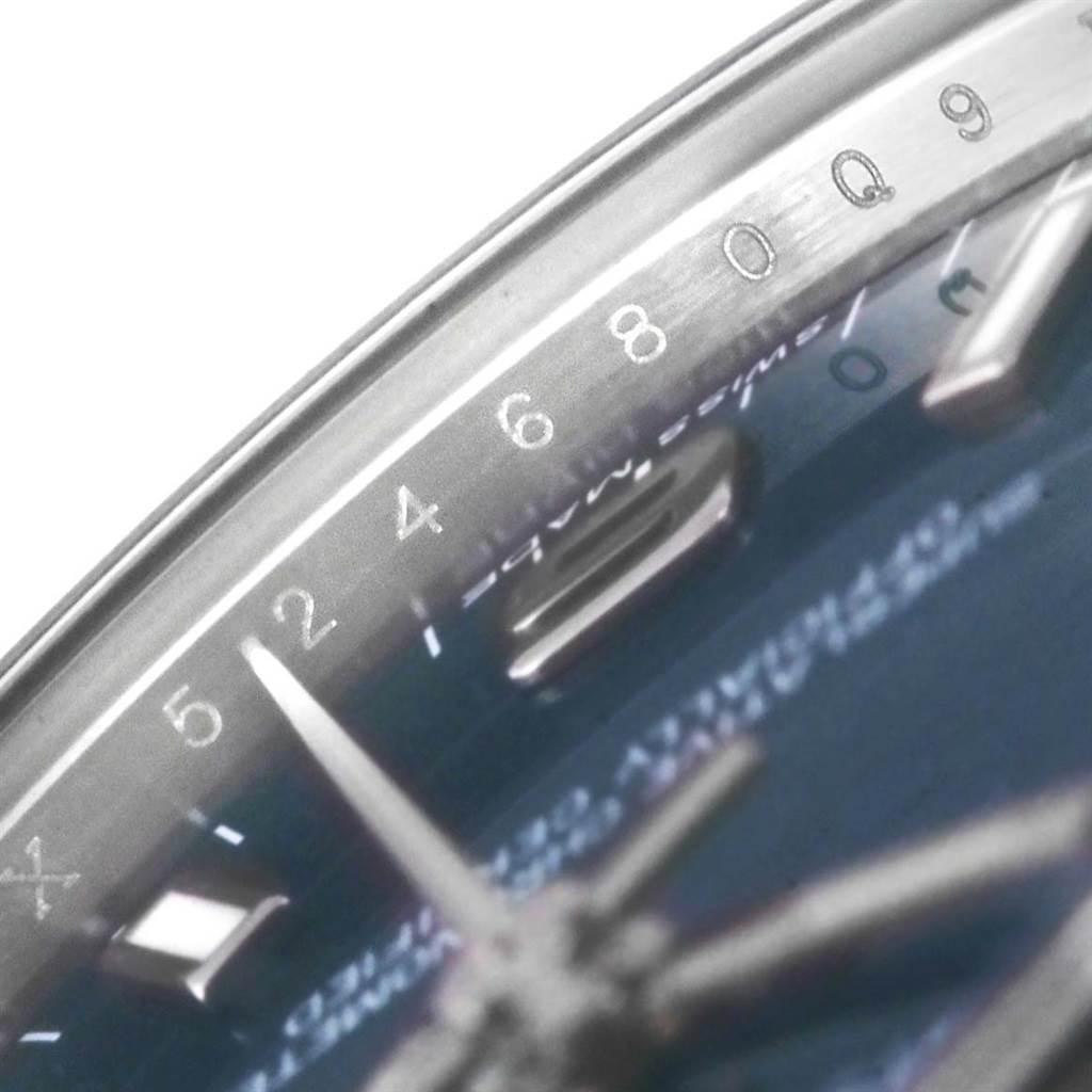The close-up angle shows the face and part of the bezel of the Mid-Size Rolex watch, highlighting the numbers and markers.