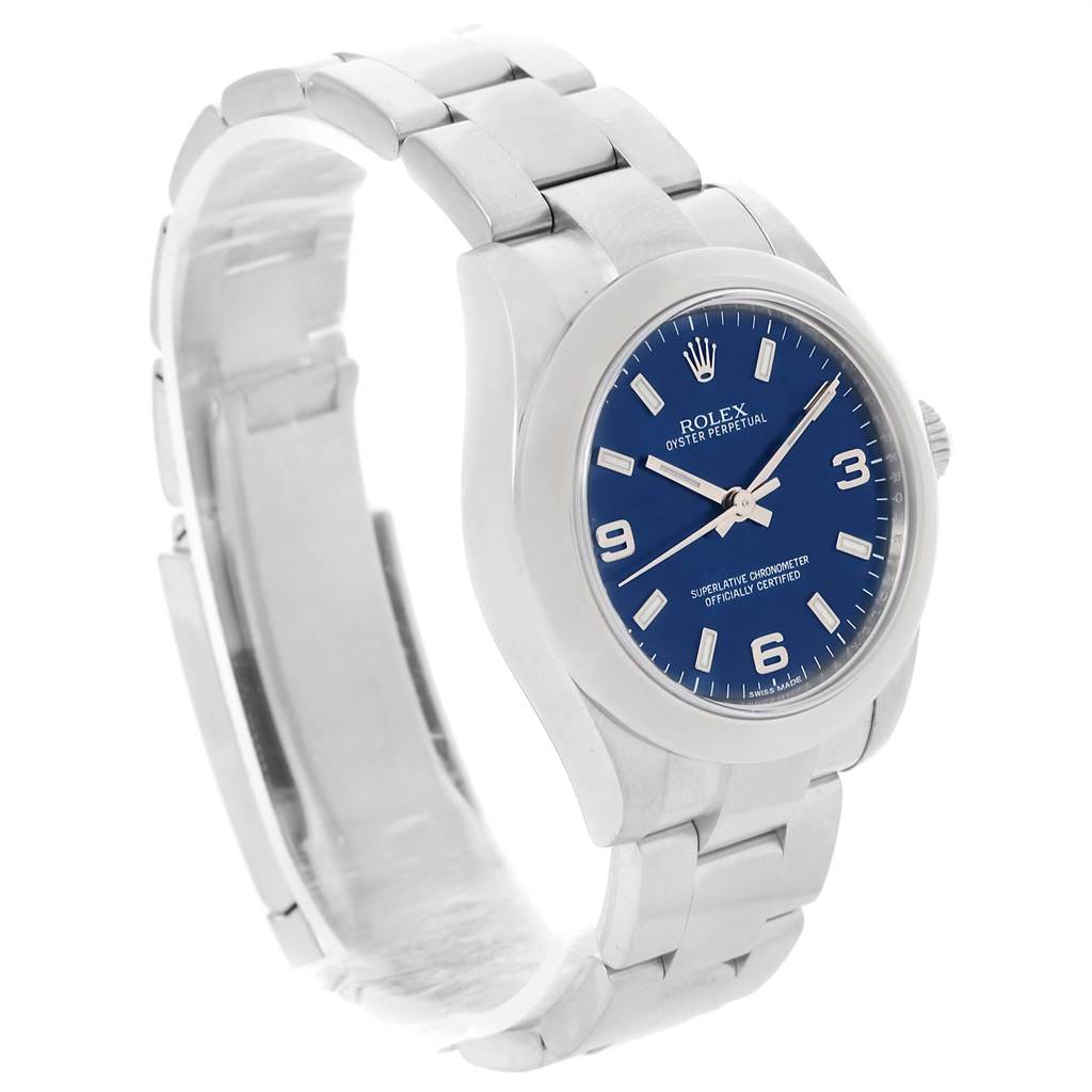 The image shows a Rolex Mid-Size 177200 Women's Stainless Steel Blue Dial 177200 Women's Stainless Steel Blue Dial Oyster Perpetual watch with a blue dial, silver case, and bracelet from a side-angle view.