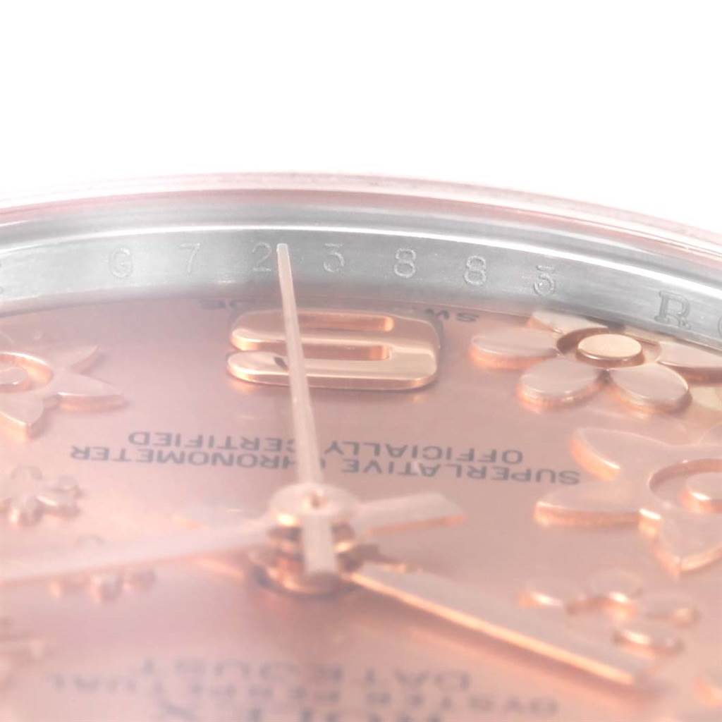 Close-up angle of the Rolex Mid-Size 178241 Women's Steel and Gold (two tone) Pink Dial 178241 Women's Steel and Gold (two tone) Pink Dial watch showing part of the dial, floral details, and the serial number.