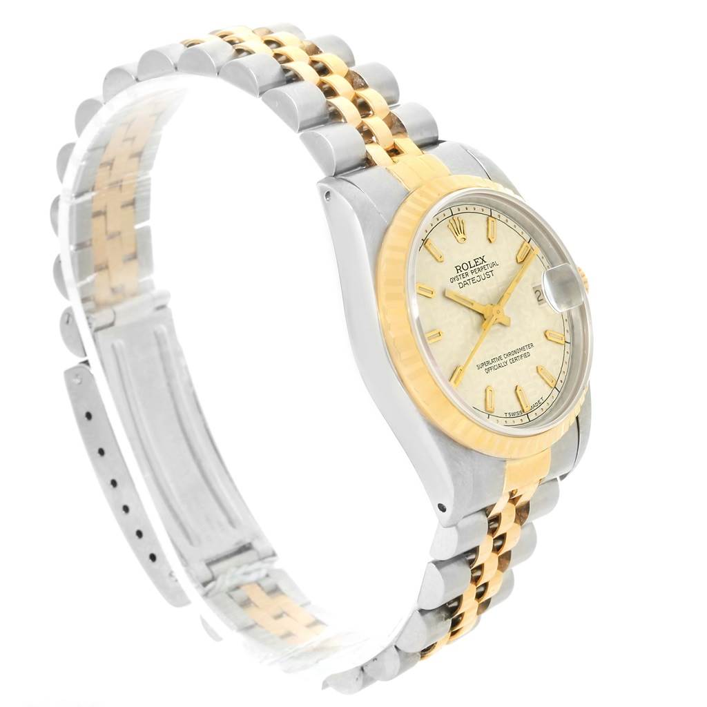 The image shows a side angle of the Rolex Mid-Size 68273 Women's Steel and Gold (two tone) Beige Dial 68273 Women's Steel and Gold (two tone) Beige Dial Datejust watch, highlighting the face, bezel, and bi-metal bracelet.