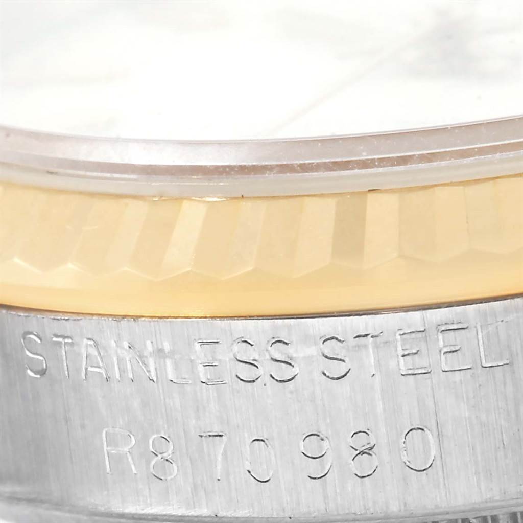 Close-up view of a Rolex Mid-Size 68273 Women's Steel and Gold (two tone) Beige Dial 68273 Women's Steel and Gold (two tone) Beige Dial watch showing the stainless steel case and part of the bezel.