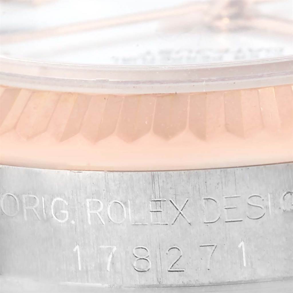 Close-up of the case and bezel of a Rolex Mid-Size 178271 Women's Steel and Gold (two tone) White Dial 178271 Women's Steel and Gold (two tone) White Dial 178271 watch, showing engraved details.