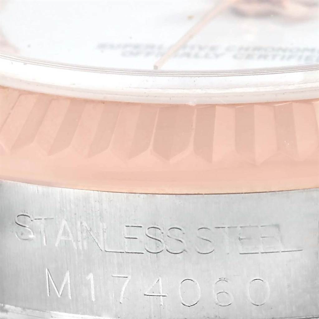 The image shows a partial close-up of a Rolex Mid-Size 178271 Women's Steel and Gold (two tone) White Dial 178271 Women's Steel and Gold (two tone) White Dial model watch focusing on the case side with engraved text.