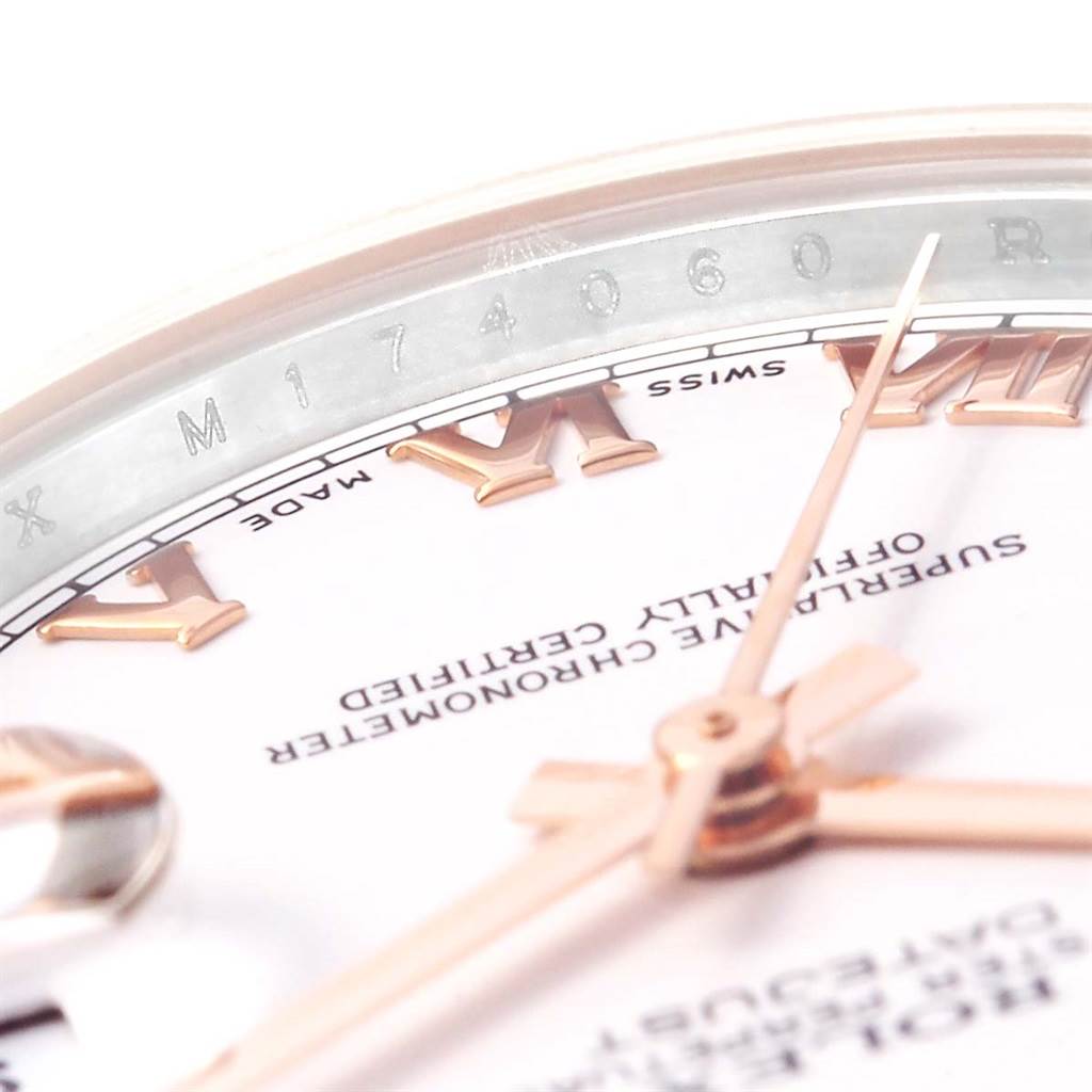 The image shows a close-up angle of the face and bezel of a Mid-Size Rolex watch, featuring Roman numerals and the model number.