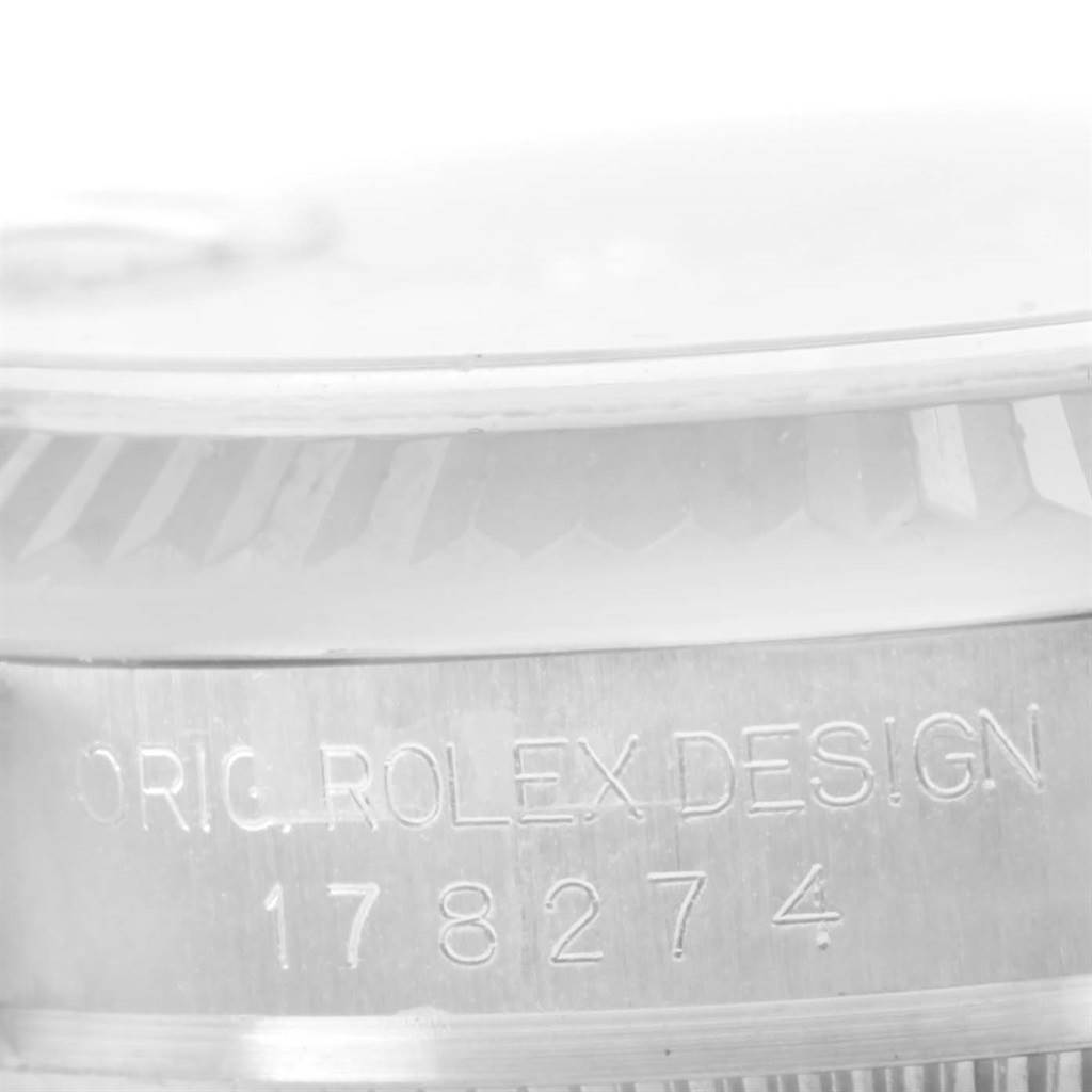 This close-up image shows the model number 178274 and inscription on the case of a Mid-Size Rolex watch.