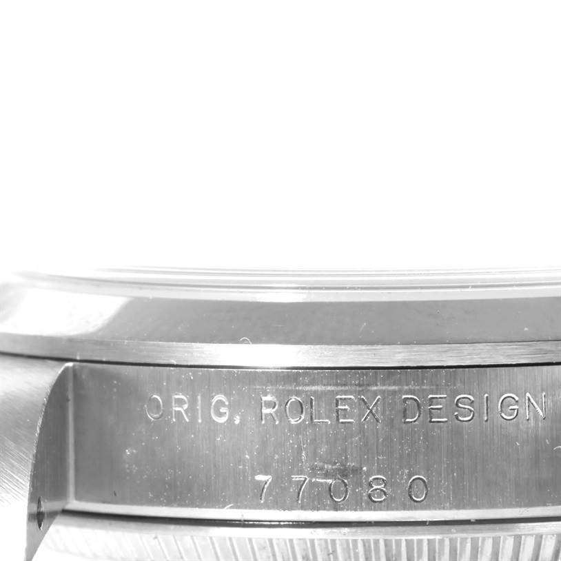 The image shows a close-up side view of the case body and bezel of a Rolex Mid-Size 77080 Men's Stainless Steel Black Dial 77080 Men's Stainless Steel Black Dial model with visible engraving.