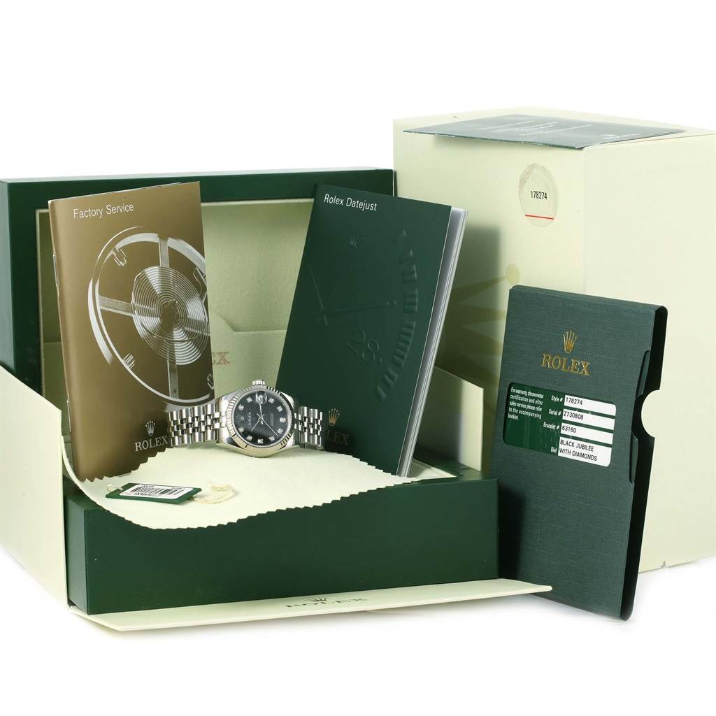 The Rolex Mid-Size 178274 Women's Stainless Steel Black Dial 178274 Women's Stainless Steel Black Dial watch is shown in its original packaging along with manuals and warranty card displayed at an angle.