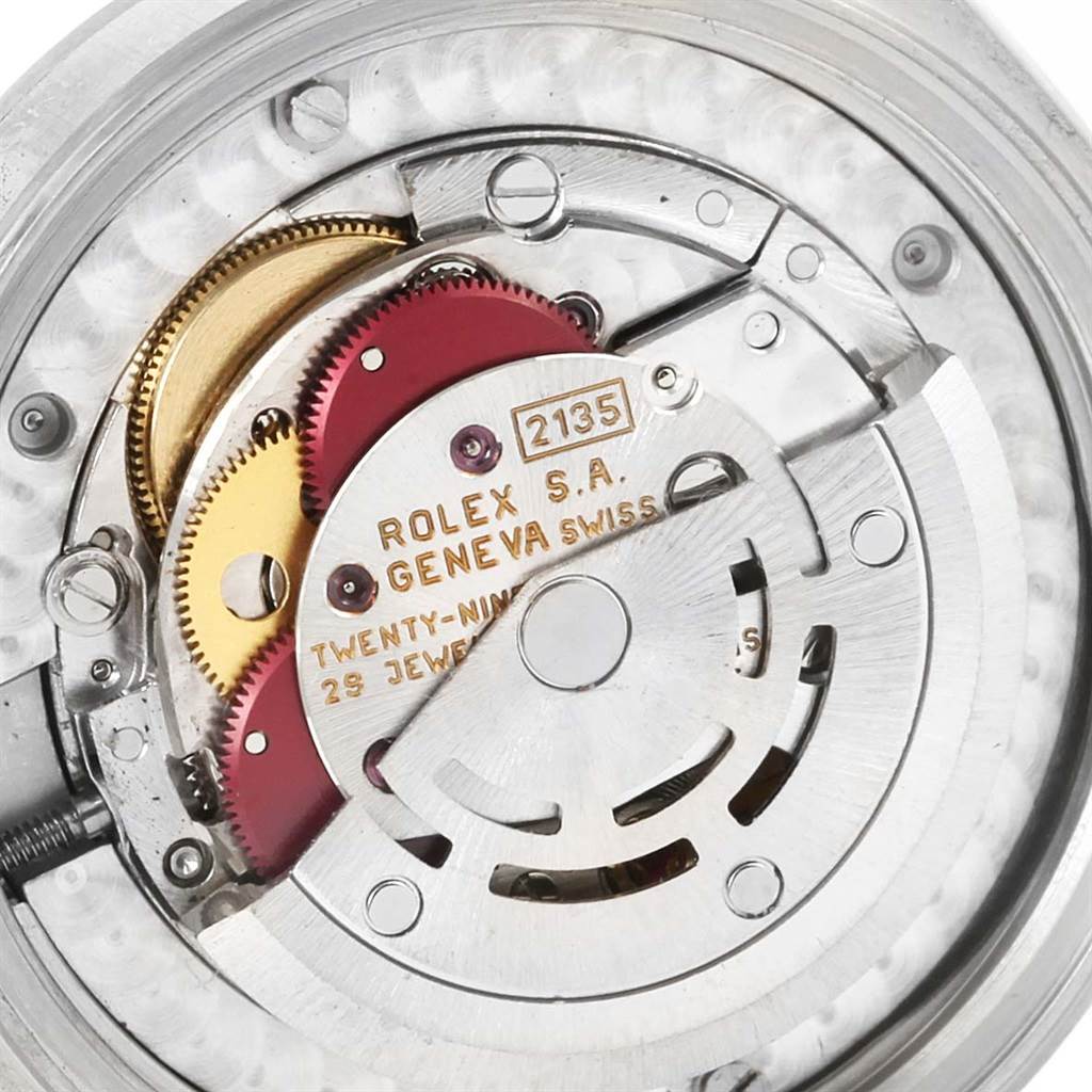 This image shows the internal mechanism and movement of a Rolex Mid-Size 68240 Women's Stainless Steel White Dial 68240 Women's Stainless Steel White Dial model, highlighting parts like gears and the rotor.