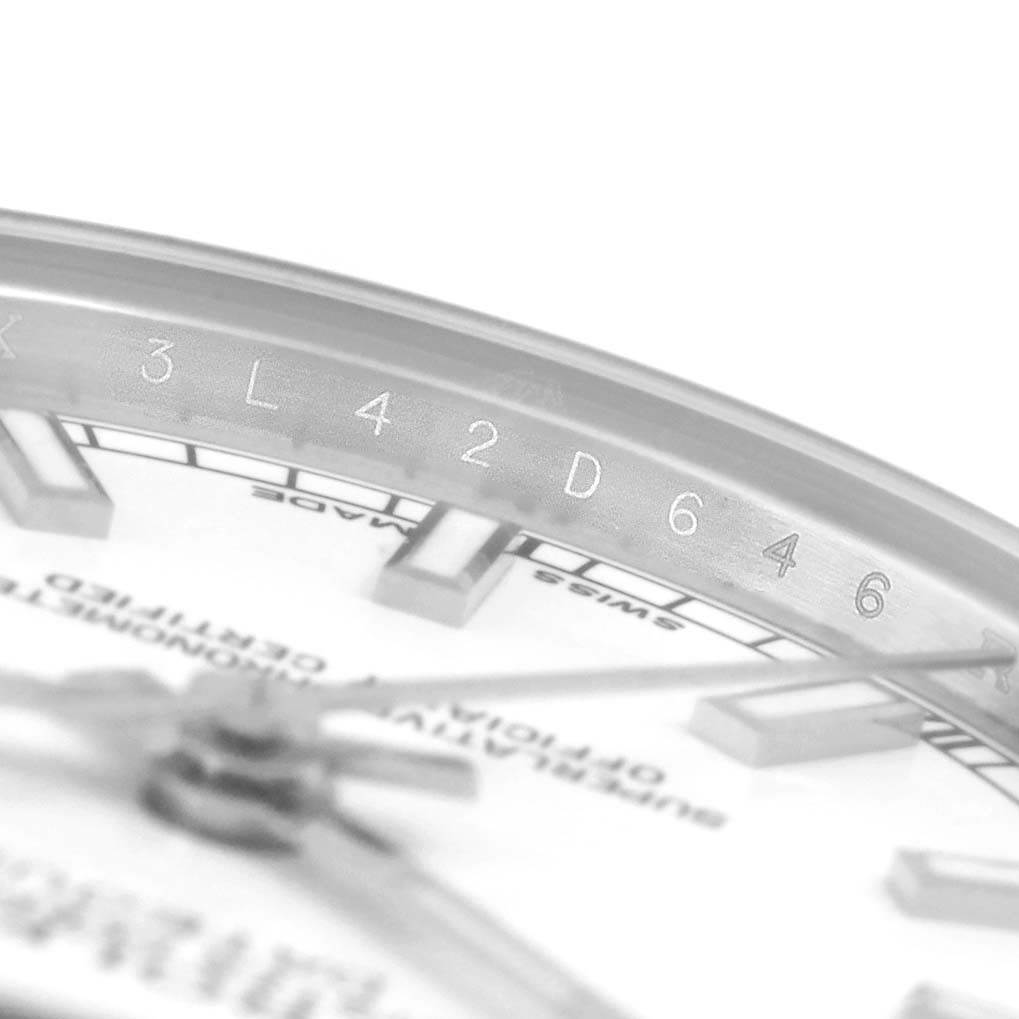 The image shows a close-up angle of the dial and bezel of a Mid-Size model Rolex watch, focusing on the indices and part of the serial number.