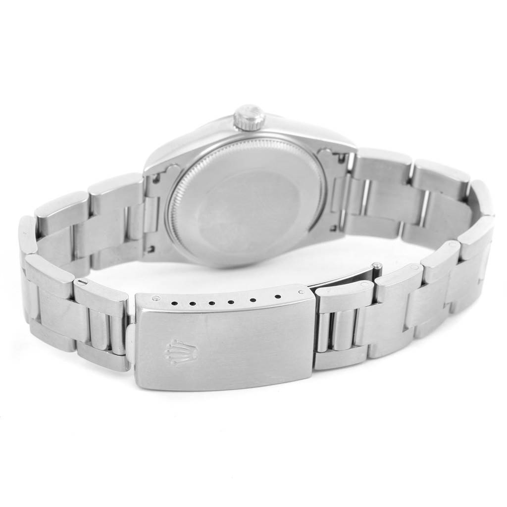 The image shows the back and bracelet clasp of a Mid-Size Rolex watch from a rear angle.