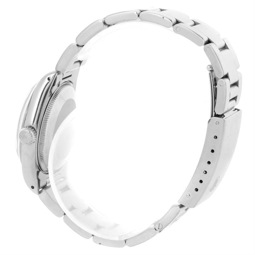 This side view of the Rolex Mid-Size 67480 Women's Stainless Steel Black Dial 67480 Women's Stainless Steel Black Dial model shows the bracelet, clasp, crown, and part of the watch case.