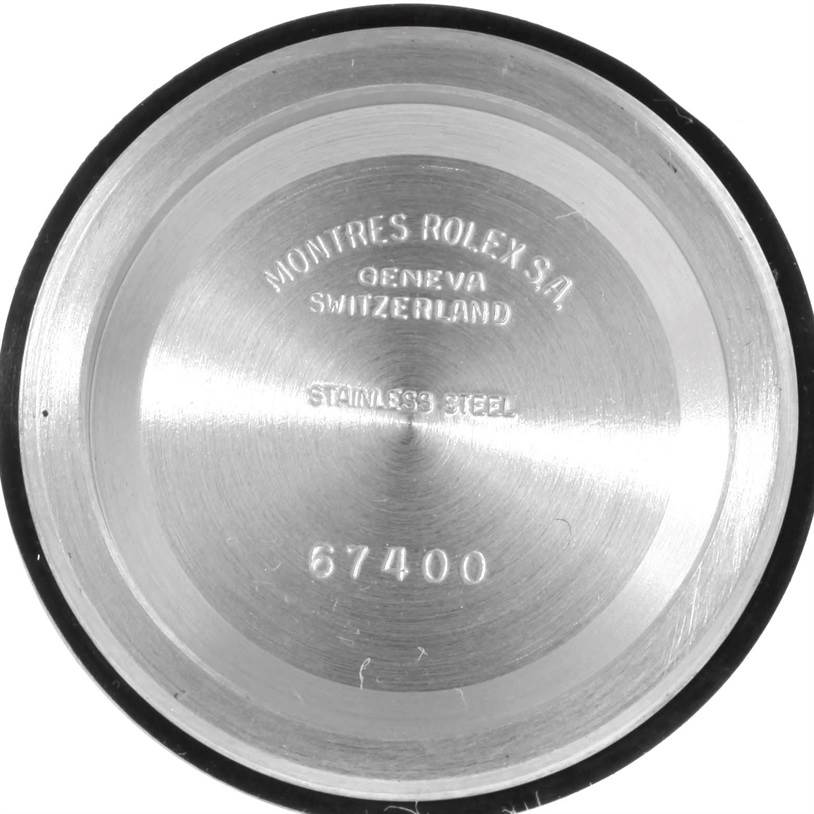 The image shows the inside case back of a Mid-Size Rolex watch, engraved with model number 67400 and other information.