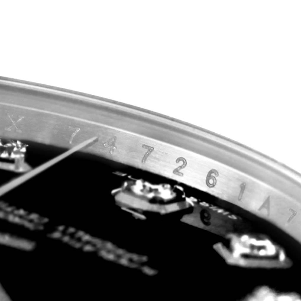The close-up of the Rolex Mid-Size 178344 Women's Stainless Steel Black Dial 178344 Women's Stainless Steel Black Dial model watch shows the bezel with engraved numbers and part of the dial.